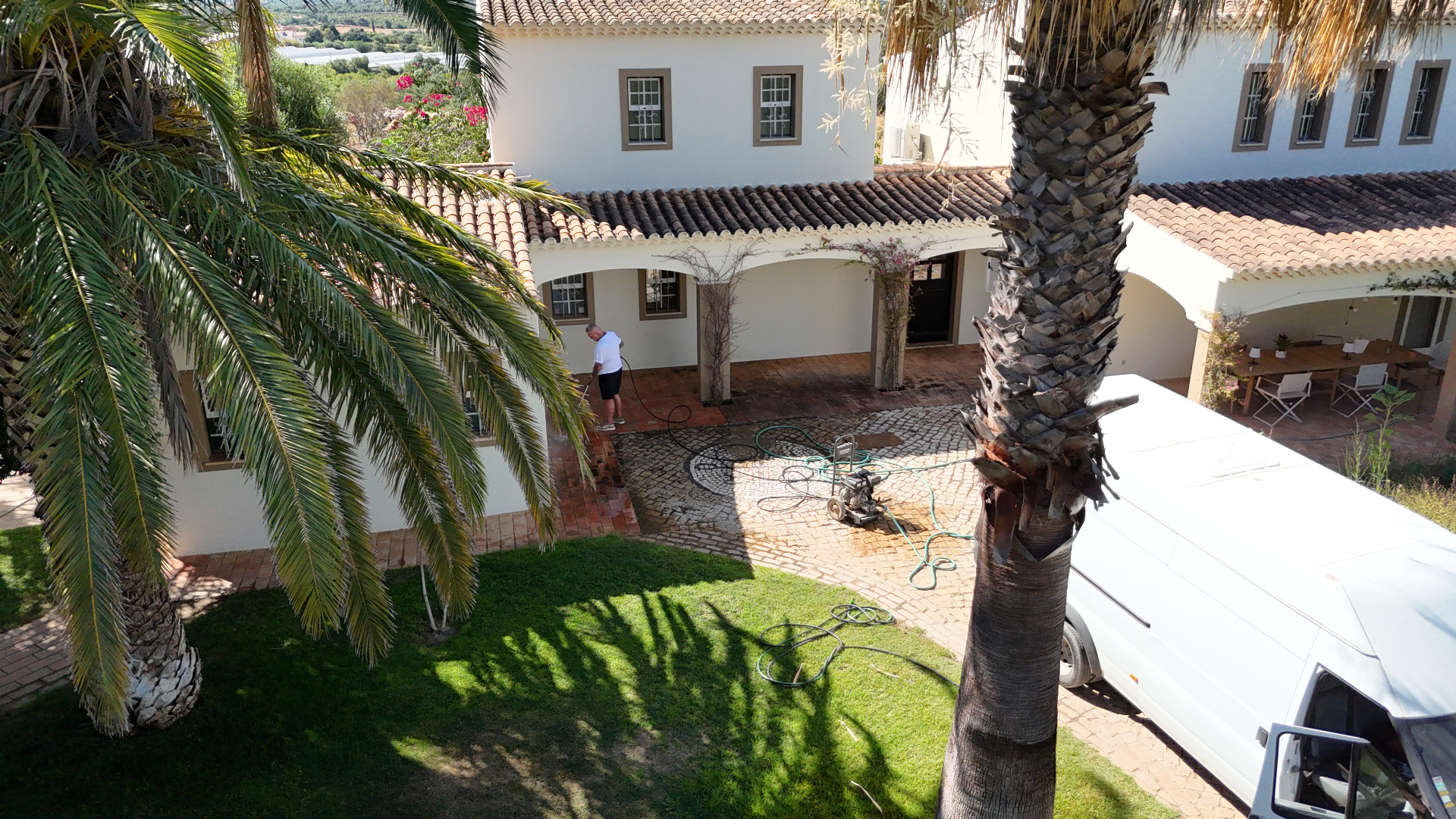 Whitehouse Services van on-site pressure washing a villa courtyard in the Algarve Golden Triangle